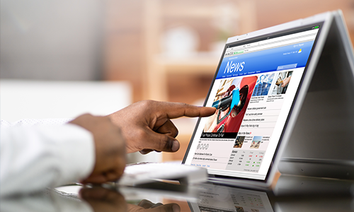 person tapping a tableet device with charts in view