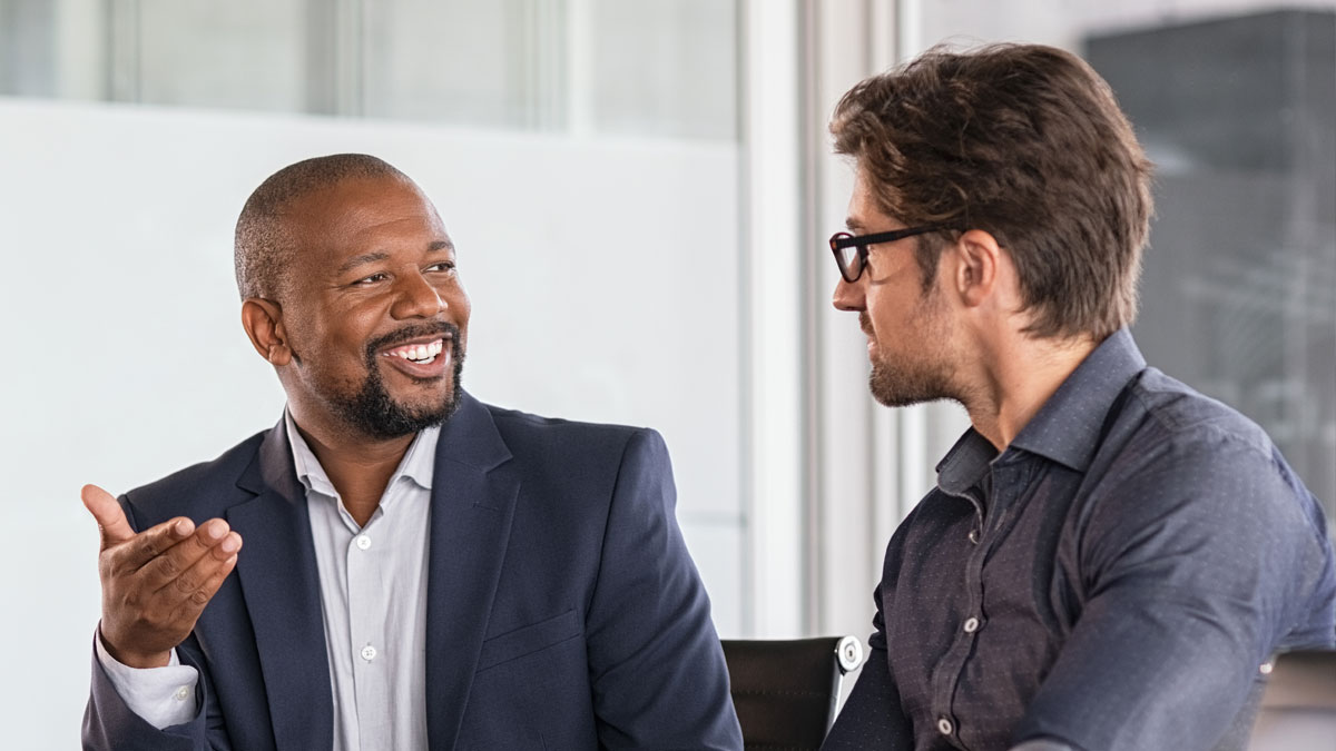 person looking through a viewpoint of a camera on a tripod